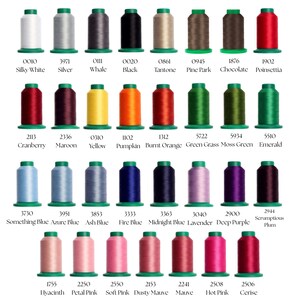 May include: A collection of thirty-two spools of embroidery thread arranged in four rows. Each spool features a unique color, including shades of white, gray, black, brown, red, yellow, orange, green, blue, purple, and pink, with labels.