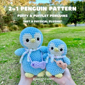 May include: Two crocheted penguin plushies, one larger and one smaller, both blue with white accents and wearing scarves. The larger penguin is holding a purple bag and the smaller penguin is holding an orange heart. The text "2 in 1 Penguin Pattern Puffy & Pufflet Penguins *Not a Physical Plushie*" is displayed above the penguins.
