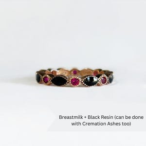 May include: A gold band ring with black resin and pink gemstones. Breastmilk + Black Resin (can be done with Cremation Ashes too)