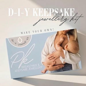 May include: A light blue box with the text "D-I-Y KEEPSAKE jewellery kit" and "MAKE YOUR OWN!". The box also says "BREASTMILK & KEEPSAKE JEWELLERY". The image shows a person holding a baby.