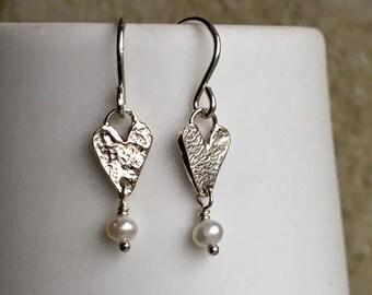 Small silver heart and freshwater pearl earrings.