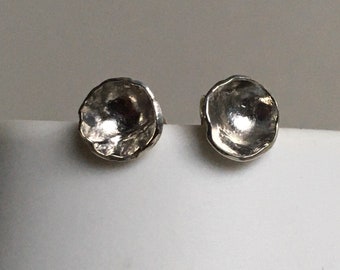 Silver cup stud earrings.