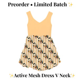 May include: An active mesh dress with a V-neck design. The top is a solid peach color, and the skirt features a pattern of Pluto's face on a striped background. The text "Preorder • Limited Batch" and "Active Mesh Dress V Neck" are visible.