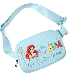 May include: Pale blue fanny pack featuring Ariel, Flounder, and Sebastian from The Little Mermaid. The pack has a matching adjustable strap and a zip closure. Text on the pack reads "Part Of Your World".