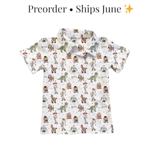 May include: White collared shirt with a pattern of cartoon characters. The shirt features short sleeves and a button-down collar. The text "Preorder &bull; Ships June" is at the top of the image.