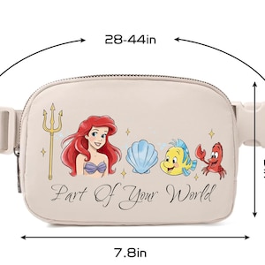 May include: Beige fanny pack with Ariel, Flounder, Sebastian, and a seashell graphic. The text "Part Of Your World" is printed on the front. The bag measures 19.8 cm wide, 12.7 cm high, and the strap adjusts from 71 to 112 cm.