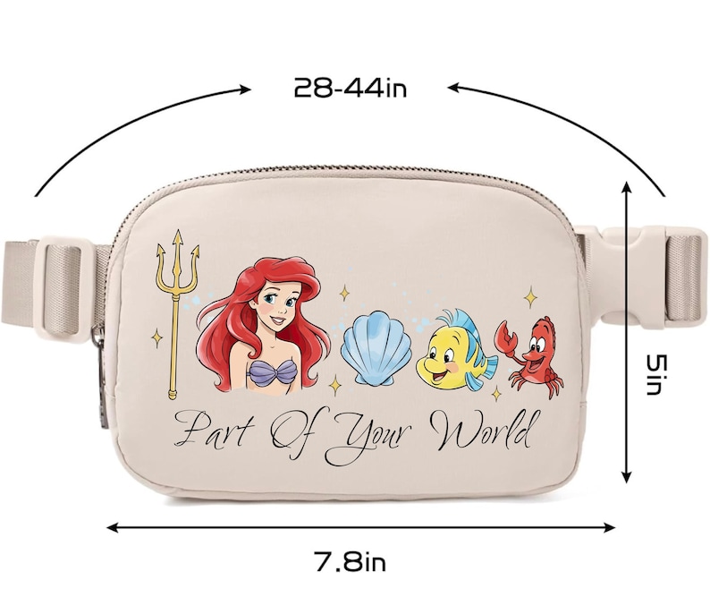 May include: Beige fanny pack with Ariel, Flounder, Sebastian, and a seashell graphic. The text "Part Of Your World" is printed on the front. The bag measures 19.8 cm wide, 12.7 cm high, and the strap adjusts from 71 to 112 cm.