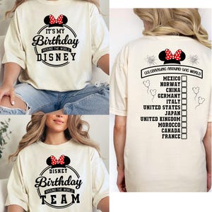 May include: Cream-colored t-shirt with a Minnie Mouse bow graphic. The front of the shirt says "It's My Birthday Around the World Disney". The back of the shirt says "Celebrating Around the World" with a list of countries.