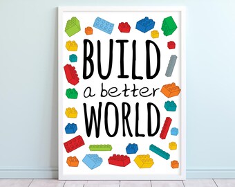 May include: A white framed print with the text "BUILD a better WORLD" in black. The background is white with colorful toy building blocks scattered around the text.