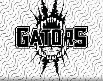 Könnte beinhalten: Schwarzweißes Grafikdesign eines Alligatormauls mit scharfen Zähnen und dem Wort "GATORS" in fetten Buchstaben.