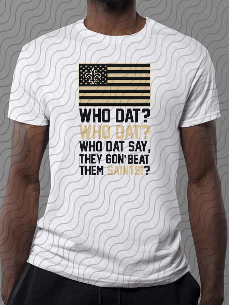 May include: A white t-shirt with a black and gold American flag design featuring the New Orleans Saints logo. The text "WHO DAT? WHO DAT? WHO DAT SAY, THEY GON' BEAT THEM SAINTS!?" is printed on the shirt.