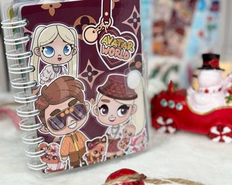 May include: A spiral-bound notebook with a dark maroon cover featuring a repeating logo pattern and cartoon-style characters. The cover displays the text Avatar World inside a heart-shaped graphic, along with illustrations of three children and a small animal.