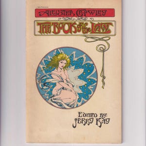 May include: A vintage book cover featuring a woman with blonde hair and a blue background with stars. The title of the book is "The Book of the Law" by Aleister Crowley. The book is edited by Jerry Kay.