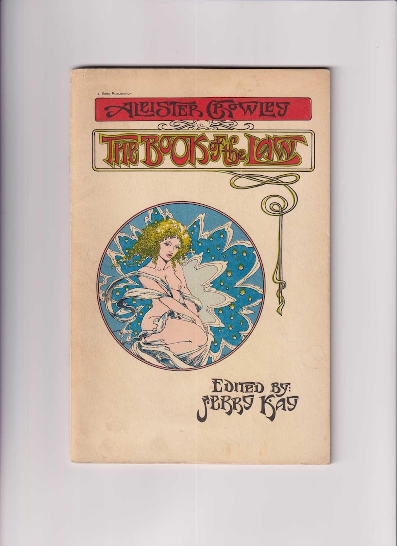 May include: A vintage book cover featuring a woman with blonde hair and a blue background with stars. The title of the book is "The Book of the Law" by Aleister Crowley. The book is edited by Jerry Kay.