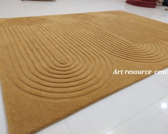 May include: A mustard yellow rug with a geometric pattern of concentric circles. The rug is made of a soft, plush material and has a modern design.