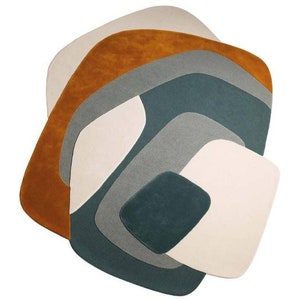 Puede incluir: Alfombra de &aacute;rea abstracta con un dise&ntilde;o de m&uacute;ltiples capas en tonos de blanco, beige, azul verdoso, gris y naranja.