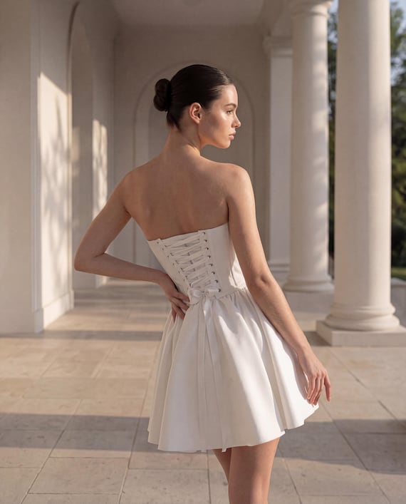 white corset dress short Mini this playful dress boasts a puffy tulle underskirt that adds volume and fun Camille white corset mini dress