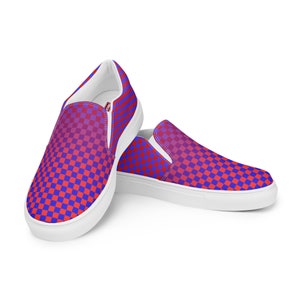May include: A pair of white slip-on canvas shoes with a red and blue checkered pattern. The pattern fades from red to blue.