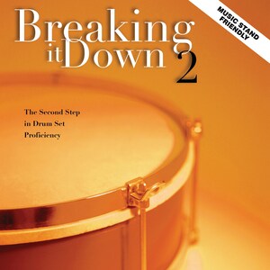 May include: A book cover with the title "Breaking it Down 2" in large, bold letters. The cover features a close-up of a gold drum with a brown drumhead. The text "The Second Step in Drum Set Proficiency" is below the title. The book is labeled "Music Stand Friendly".
