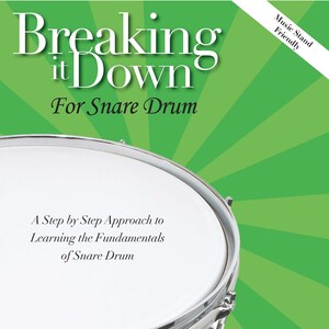 May include: A green and white book cover with the title "Breaking it Down For Snare Drum". The cover features a close-up of a snare drum with the text "A Step by Step Approach to Learning the Fundamentals of Snare Drum".