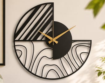 May include: A circular wall clock featuring a black metal frame with a split design. The upper left quadrant has diagonal lines, while the lower half displays organic, flowing contour lines. It includes gold-colored clock hands at the center.