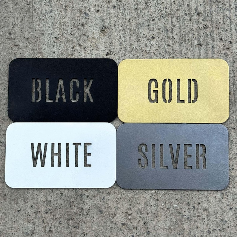 four rectangular metal plates, each with a different color and text, arranged in a square formation.