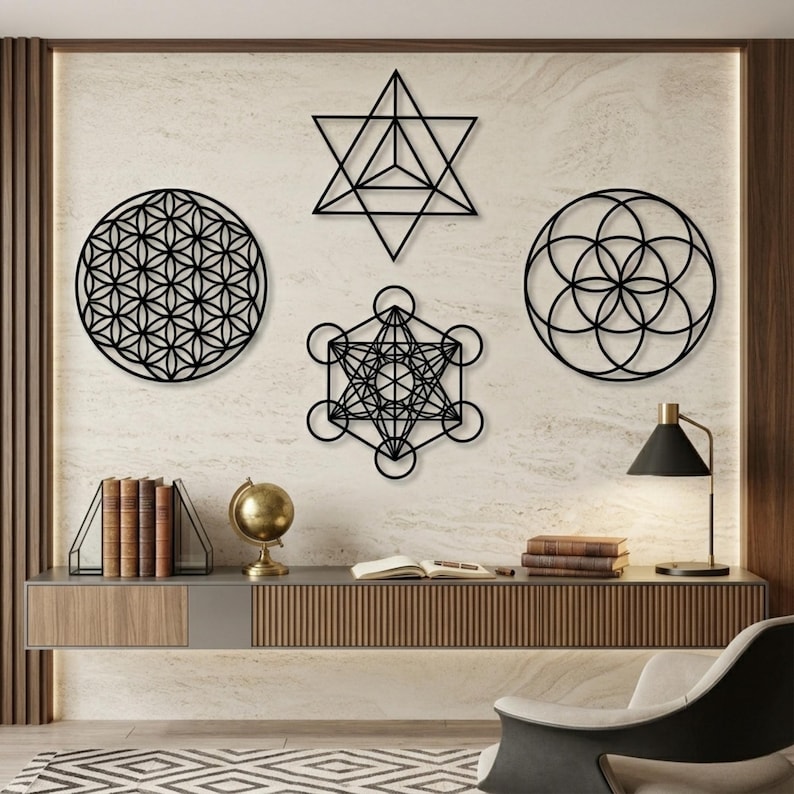 May include: Black metal wall art featuring geometric shapes, including a flower of life, Metatron's Cube, and a star tetrahedron. The art is displayed on a textured, light-colored wall above a modern console table with books and a globe.