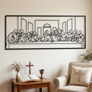 May include: A black metal wall art piece featuring a linear, minimalist outline of The Last Supper. The rectangular frame encloses the figures of thirteen individuals seated at a long table, rendered in a continuous, thin black metal wire design.