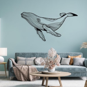Nautical metal wall art of a swimming whale for living room