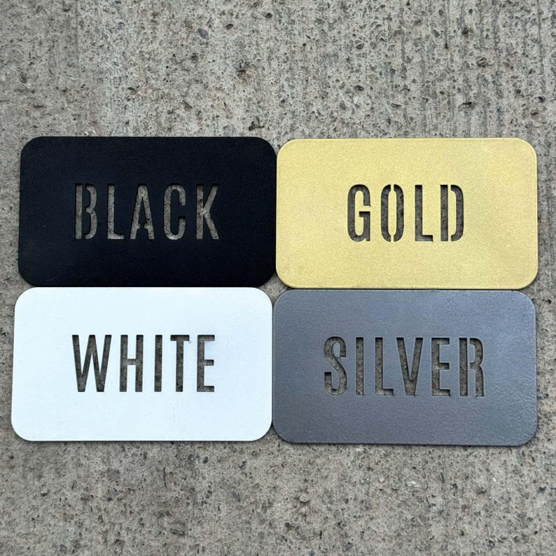 four rectangular metal plates, each with a different color and text, arranged in a square formation.