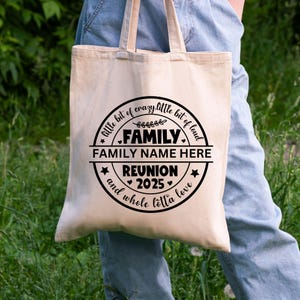 May include: A white canvas tote bag with a black circle design that says "little bit of crazy.little bit of loud", "FAMILY", "FAMILY NAME HERE", "REUNION 2025", and "and whole lotta love".