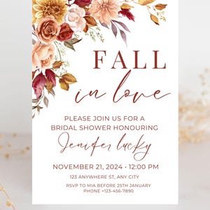 May include: A bridal shower invitation with the words "FALL in love" in burgundy script. The invitation includes details for Jennifer Lucky's shower, with a floral arrangement in the upper left corner. The flowers are in shades of orange, red, and white.