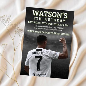 May include: A black and white birthday invitation with a soccer player in a white jersey with the number 7 on the back. The text on the invitation reads "WATSON'S 7TH BIRTHDAY SATURDAY, 20TH DEC, 2024 AT 2 PM 123 Anywhere St., Any City, ST 12345 Rsvp to Olivia 123-456-7890 by 10 dec, 2024 WAER YOUR FAVORITE TEAM JURSEY! RONALDO 7 Cygames"