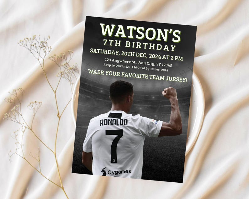 May include: A black and white birthday invitation with a soccer player in a white jersey with the number 7 on the back. The text on the invitation reads "WATSON'S 7TH BIRTHDAY SATURDAY, 20TH DEC, 2024 AT 2 PM 123 Anywhere St., Any City, ST 12345 Rsvp to Olivia 123-456-7890 by 10 dec, 2024 WAER YOUR FAVORITE TEAM JURSEY! RONALDO 7 Cygames"