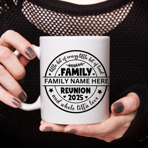 May include: White ceramic mug with a black circle design that says "little bit of crazy, little bit of loud, FAMILY, FAMILY NAME HERE, REUNION 2025, and whole lotta love".