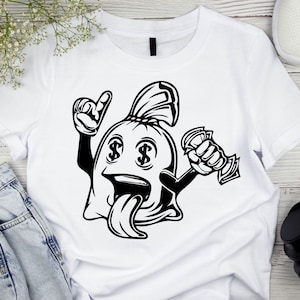 May include: A white t-shirt with a black and white illustration of a money bag with dollar signs for eyes, a tongue sticking out, and a hand holding money. The money bag is wearing a hat.
