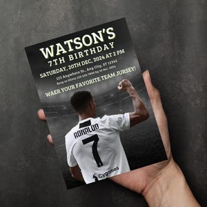 May include: A black and white birthday invitation with a soccer player in a white jersey with the number 7 and the name "RONALDO" on the back. The invitation is for Watson's 7th birthday party on Saturday, December 20th, 2024 at 2 PM. The invitation includes the address and RSVP information.