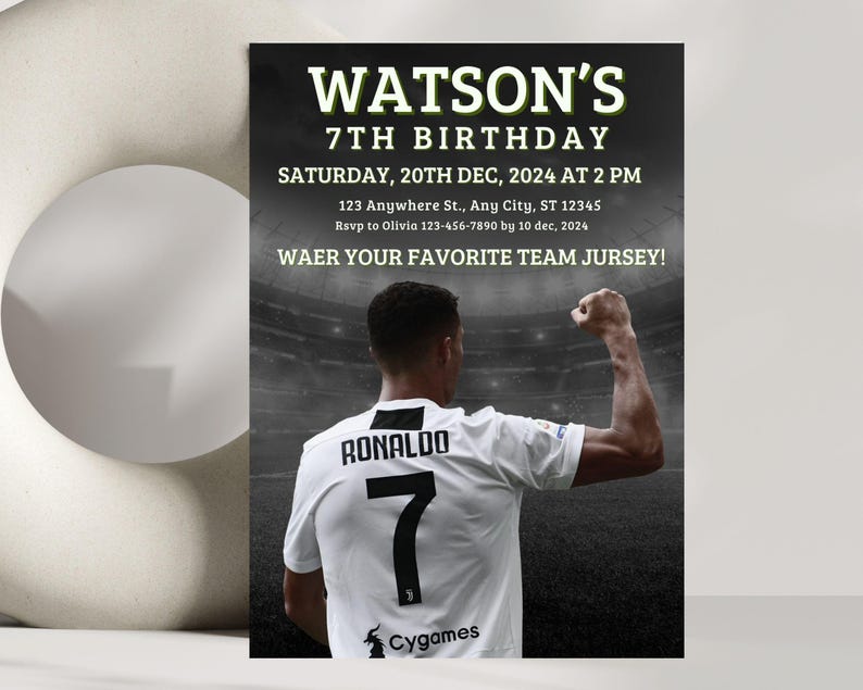 May include: A black and white birthday invitation with a soccer player wearing a white jersey with the number 7 and the name "RONALDO" on the back. The invitation says "WATSON'S 7TH BIRTHDAY" and includes the date, time, and location of the party. It also says "WAER YOUR FAVORITE TEAM JURSEY!"