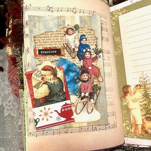 May include: Open book with vintage Christmas-themed collage. The collage features children on sleds, Santa Claus, and a red teapot illustration. The word "Precious" is visible. The book's pages have musical notes.