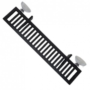 May include: Black metal grate with two white plastic mounting brackets. The grate is rectangular and designed for use in a fireplace or stove.