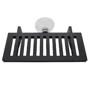 May include: Black plastic aquarium plant holder with a suction cup. The holder has a grid pattern and is designed to hold plants in an aquarium.
