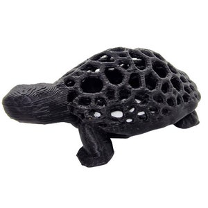 May include: A black 3D printed turtle figurine with a detailed, intricate shell design.