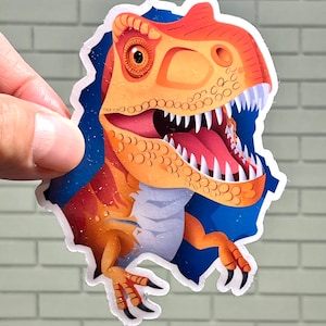 May include: A sticker of a cartoon orange and brown dinosaur with a blue background. The dinosaur is peeking out of a hole in the sticker.