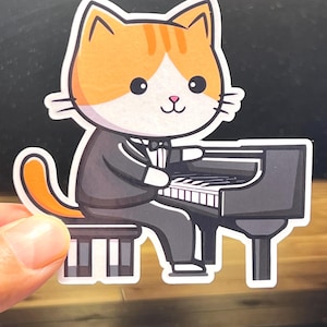 May include: A cartoon orange tabby cat wearing a tuxedo plays a black grand piano. The cat is sitting on a piano bench and has a bow tie.