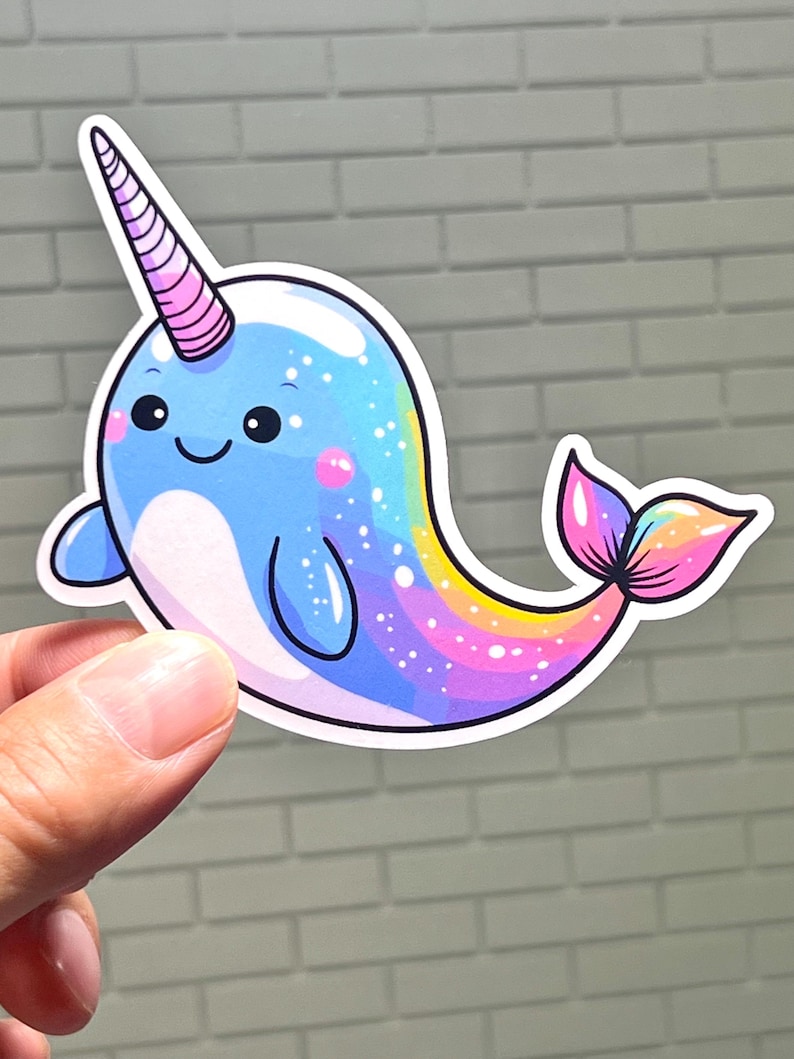 A whimsical pastel rainbow narwhal sticker designed in a charming kawaii style with a golden horn. This premium vinyl decal is shown in a small size on a clear Kindle case and in a large 5-inch size on a beach cooler to highlight its outdoor UV protection.