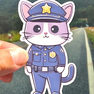 May include: A cartoon cat wearing a blue police officer uniform with a gold star on the hat. The cat has white fur and purple ears.