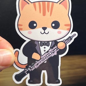 May include: A cartoon orange tabby cat wearing a tuxedo and holding an oboe. The cat has a bow tie and is smiling.