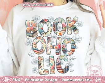 May include: White sweatshirt with a floral design that spells out "BOOKAHOLIC". The design features a variety of flowers and books.