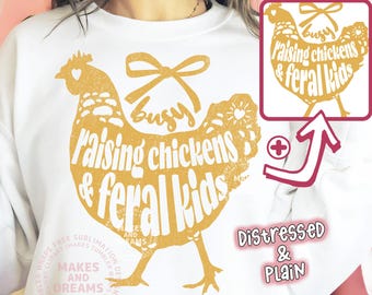 May include: White sweatshirt with a distressed gold chicken graphic. The graphic includes the text "Busy Raising chickens & feral Kids" and a bow. A smaller graphic is in the upper right corner. The words "Distressed & Plain" are below the graphic.