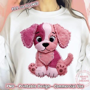 May include: White sweatshirt featuring a pink and magenta puppy design. The puppy has large ears, a black nose, and is sitting. The design includes the text "MAKES AND DREAMS" and "PNG - Printable Design - Commercial Use".
